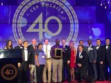 Dr. Imamu Tomlinson holding award, along with network employees 